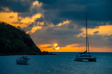 Sunset on the Caribbean beaches with anchored ships