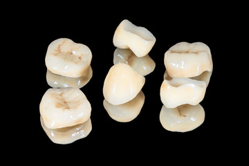 zirconium tooth crown macro. Isolate on a black background. Aesthetic restoration of tooth loss