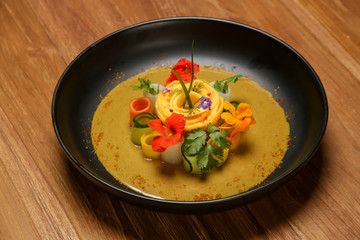 Vegetable curry with mango. Exquisite dish. Creative restaurant meal concept.	