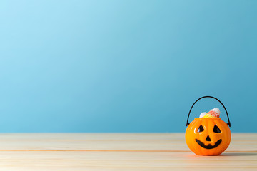 Halloween pumpkin bucket on a blue background