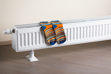 colorful socks are being dry on the radiator