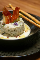 Creamy mushroom risotto. Pilaf rice with mixed herbs. Exquisite dish. Creative restaurant meal concept.	