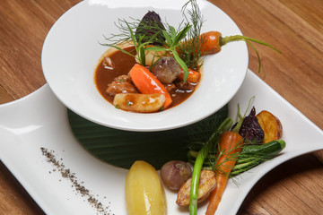 Slow-cooked pork filet in a white wine demi-glace sauce. Exquisite dish. Creative restaurant meal concept.	