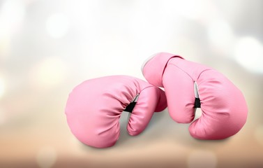 Pink boxing gloves on background