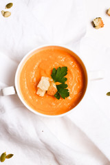 pumpkin soup with croutons on a white background