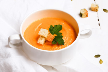 pumpkin soup with croutons on a white background