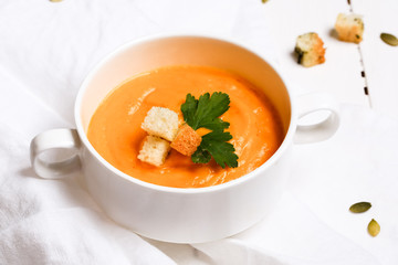 pumpkin soup with croutons on a white background