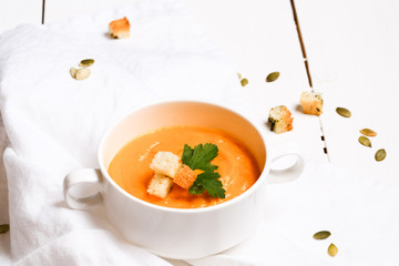 pumpkin soup with croutons on a white background