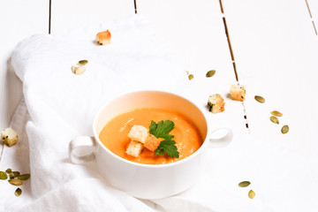 pumpkin soup with croutons on a white background