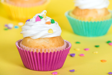 Colorful cupcakes decorated with heart shaped sprinkles