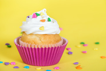 Colorful cupcake decorated with heart shaped sprinkles