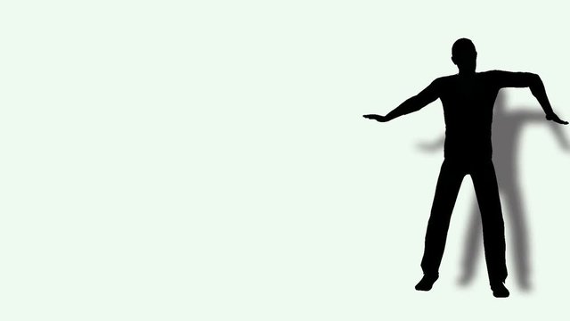 Dancing man silhouette with drop shadow on a white background.mov