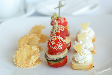 Сanape on skewer of tomatoes, cucumbers and meat