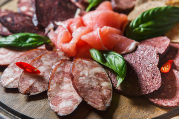 Sliced sausage and ham with greens