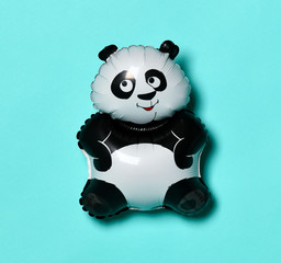 Little panda balloon for present on birthday on light blue green
