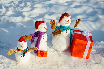 Winter portrait of handsome hipster in snow Garden with gift make snowman. Modern Santa. Holly jolly swag Christmas and noel. Christmas and new year holidays.