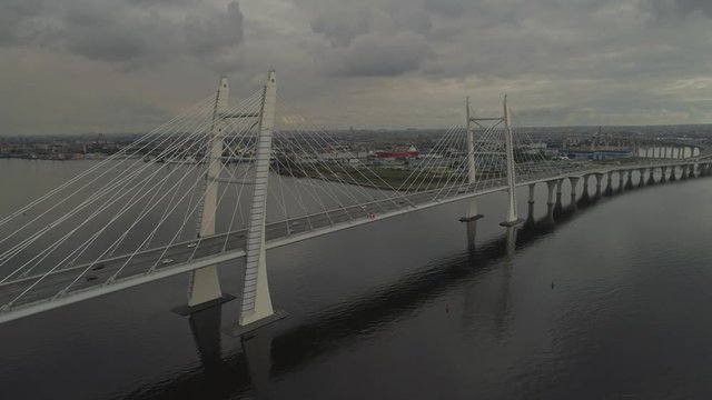 Aerial view Vant cable bridge in Saint-Petersburg. Cloudy weather, heavy traffic on road