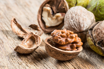 Ripe and raw whole big walnut kernel  with thin shell on wooden rustic backdrop. healthy nut food for brain. Fresh walnuts  background concept