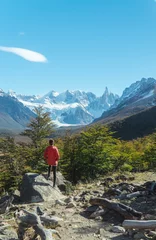 Wall murals Cerro Torre Woman hiking Mount Fitzroy, Patagonia. Tourist looking at stunning snowcapped peaks on Laguna Torre hiking trek. Walking trail for hikers. Mountains, nature, hiking. Shot in El Chalten, Argentina