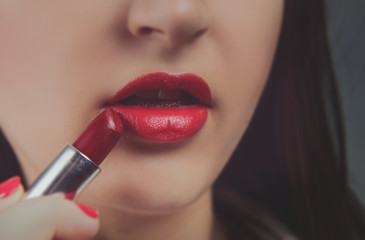 Naklejka premium Professional Make-up. Applying red liptick
