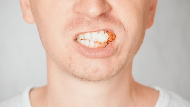 close up face fair man eating croissant portrait guy bites and chews