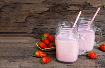Strawberry smoothies colorful fruit juice milkshake blend beverage healthy high protein the taste yummy In glass,drink episode morning on wood background.