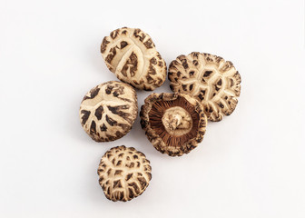 a group of dried shiitake mushroom on white background