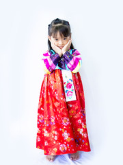 Asian little girl wearing a Korean Traditional Hanbok dress  in white background 