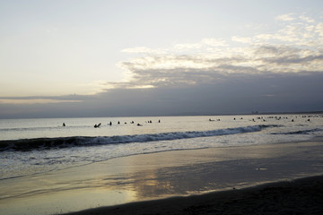 Surfers in the evening of backlight