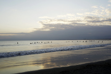 Surfers in the evening of backlight