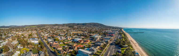 Fototapeta na wymiar Wide aerial panoramic landscape of Dromana coastline, suburb and pier on bright sunny afternoon