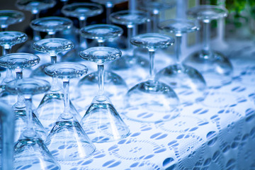 rows of empty wine/ champagne glasses were upside down arranged on the table.shallow focus effect.
