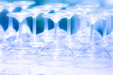 rows of empty wine/ champagne glasses were upside down arranged on the table.shallow focus effect.