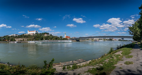 Fototapeta na wymiar Aerial view of Bratislava (Pozsony, Pressburg) on a sunny afternoon with the castle on the hilltop, saint martin church old town and bridge