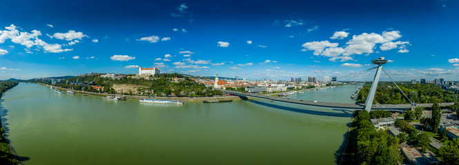 Aerial view of Bratislava (Pozsony, Pressburg) on a sunny afternoon with the castle on the hilltop, saint martin church old town and bridge