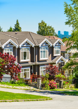 A row of townhouses on street in suburban of New Westminster, British Columbia.