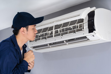 technician service checking and repairing air conditioner