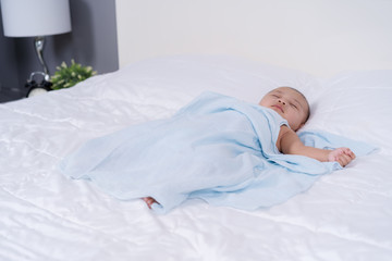 baby sleeping on a bed at home