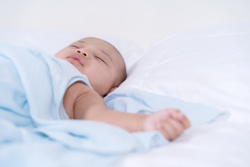 baby sleeping on a bed at home