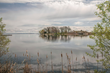 View of island in the Thousand Island chain seen from shore calm water reflections nobody