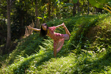 young beautiful Asian Korean woman doing yoga and relaxation exercise at fresh green forest meditating and enjoying calm and tranquility in harmony