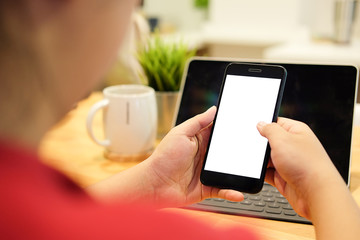 Cropped shot view of man hands holding smart phone with blank copy space screen for your text message or information content, female reading text message on cell telephone during in urban setting. 