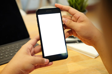 Cropped shot view of man hands holding smart phone with blank copy space screen for your text message or information content, female reading text message on cell telephone during in urban setting. 