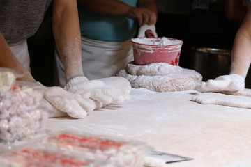 woman kneading dough on table
