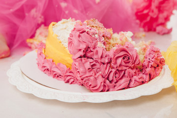 Obraz na płótnie Canvas destroyed cake on white background close-up. Confectionery decorated with roses. Baking advertising concept, calorie, nutrition, diet