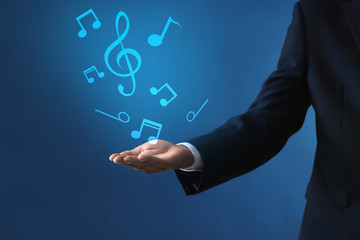 Businessman holding something on color background