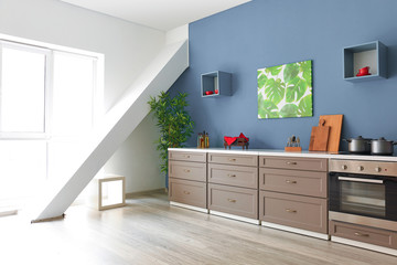 Interior of modern kitchen with stylish furniture