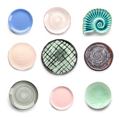 Set of different plates on white background
