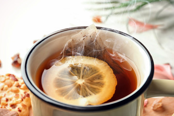Mug of hot tea with lemon on table, closeup