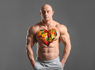 Muscular bodybuilder on grey background